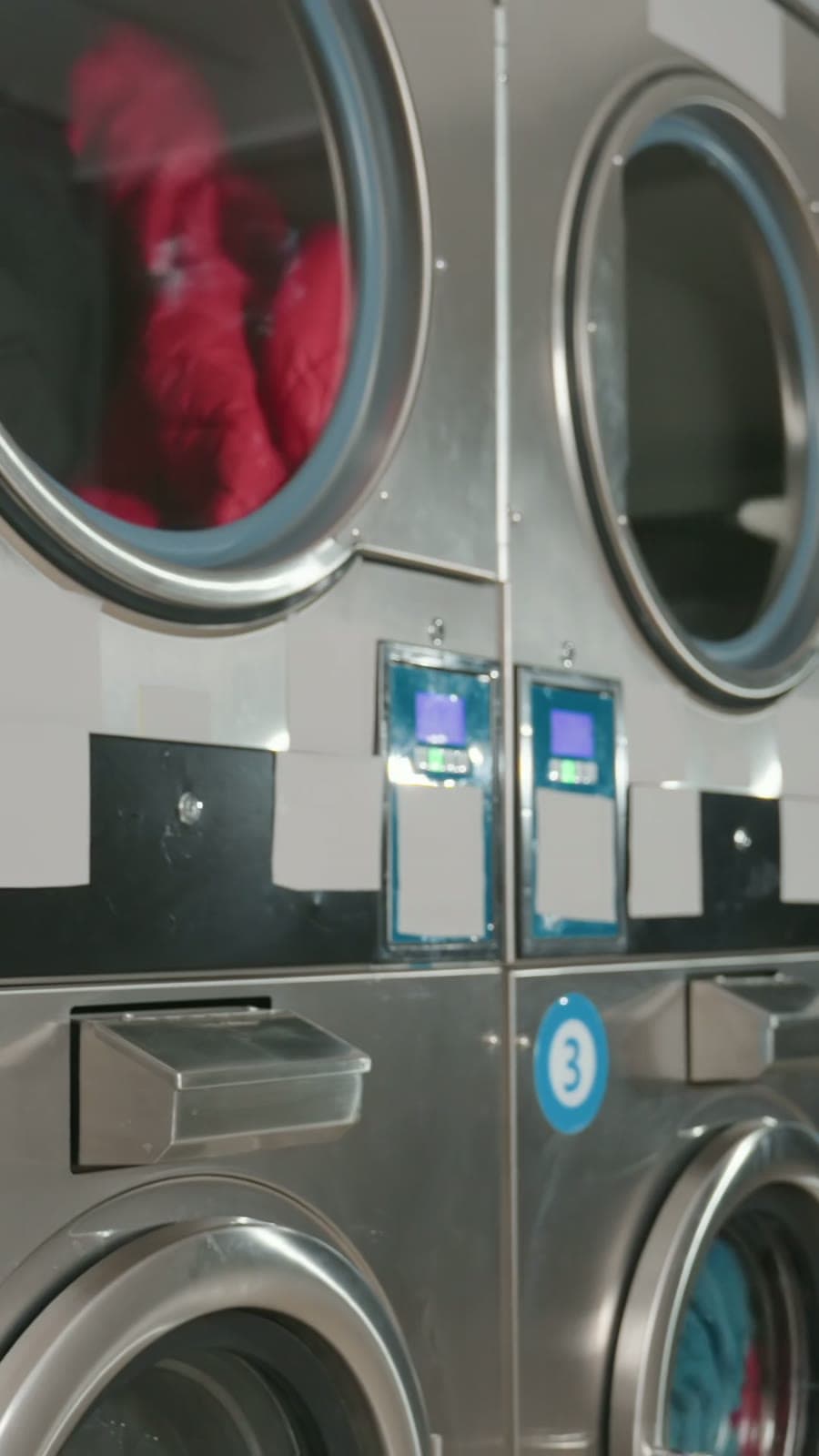 Commercial laundry machines processing a WashMe customer order