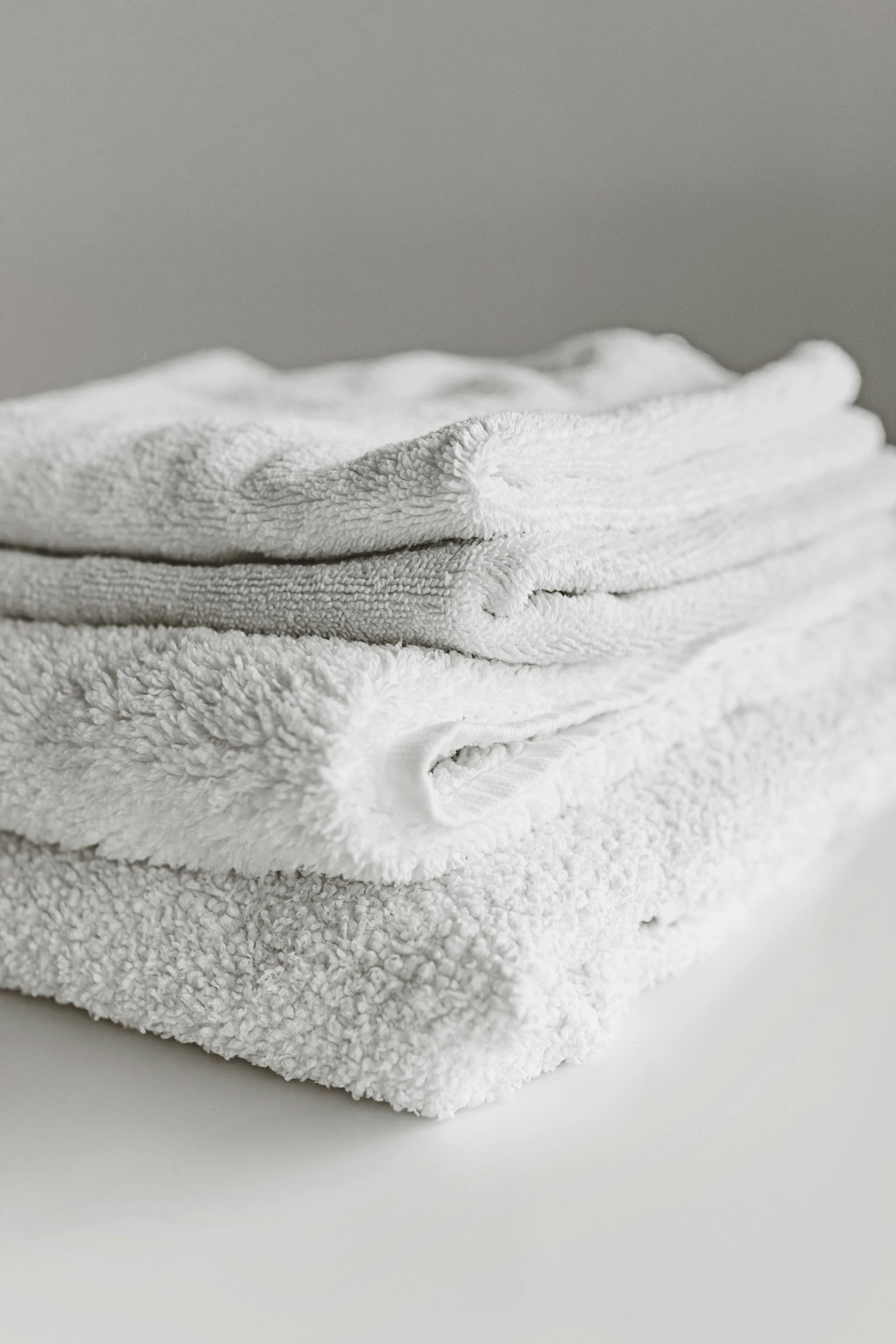 Hand-folded stack of white linens